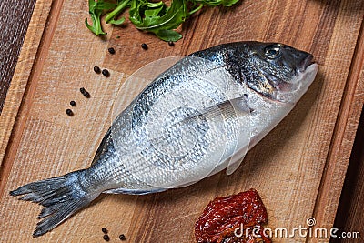 Fresh uncooked dorado fish with ingredients closeup Stock Photo