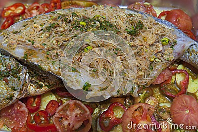 Fresh uncooked dorado or sea bream fish with tomato Stock Photo