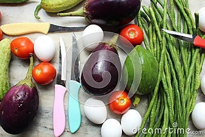 Fresh various raw organic vegetables with white eggs display for healthy and diet background. Stock Photo