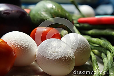 Fresh various raw organic vegetables with white eggs display for healthy and diet background. Stock Photo