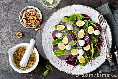 Fresh vegetable salad with boiled beet, mangold leaves, walnuts and quail eggs Stock Photo