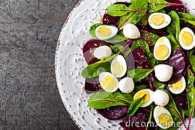 Fresh vegetable salad with boiled beet, mangold leaves, walnuts and quail eggs Stock Photo