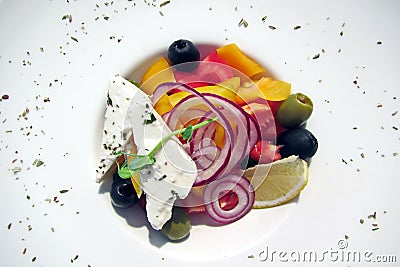 Fresh vegetable salad with cheese garnished with spices close-up. Stock Photo