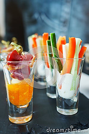Fresh vegetable sticks and meat with sauce in a glass. Snacks and canaps. Stock Photo