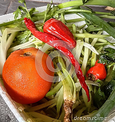 fresh vegetables consisting of pieces of pumpkin, tomatoes, cloves Stock Photo