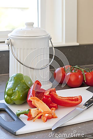 Fresh vegetables, food scraps and compost container on kitchen counter. Sustainable home lifestyles Stock Photo