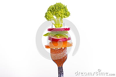 Fresh vegetables on a fork isolated on white background Stock Photo