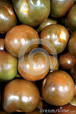 Fresh vegetables green-brown tomatoes a close up in a box, a box a background Stock Photo