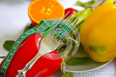 Fresh vegetables, measuring board salad various tape, fork on wooden background Stock Photo