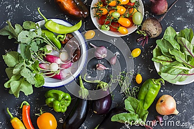 Fresh vegetables - radishes, eggplant, pepper, tomatoes, onion, garlic on a dark wooden background. Stock Photo