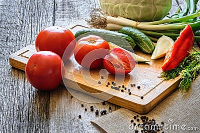 fresh vegetables tomatoes, cucumber, chili pepers, dill on wooden background. Stock Photo