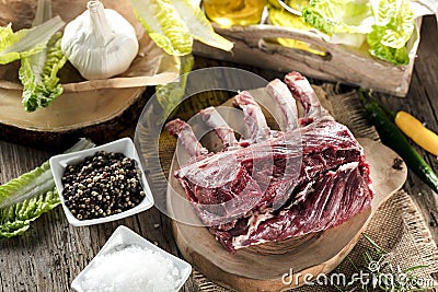 Fresh venison rack on dark wooden background. Stock Photo