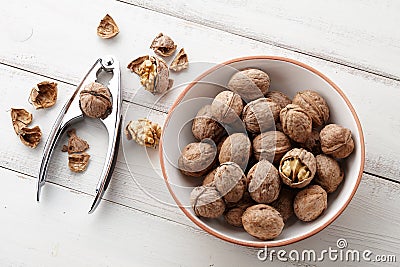 Fresh walnuts bowl on white wooden background Stock Photo