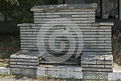 Fresh water gush from old fountain in the center of village Paunovo, Sredna Gora mountain Stock Photo