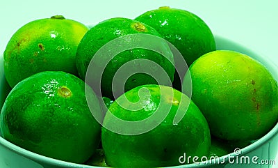 Fresh wet lemons (Citrus aurantiifolia) with water drops Stock Photo