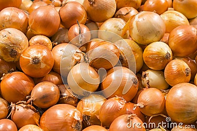 Fresh yellow onions as a background. Vegetable store. Yellow onion lies in a box in a store for sale. Vitamin C. Virus protection Stock Photo