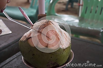 fresh young coconut that has been peeled and ready to serve. Young coconut water has many benefits to replace body ions Stock Photo