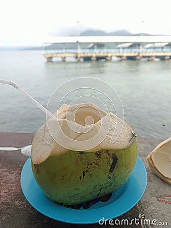 Fresh Young Coconut with Ternate Sea Background Stock Photo