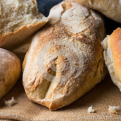 Freshly baked bread on burlap dark wooden background square Stock Photo