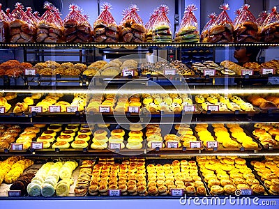 Freshly baked breads and pastries on display at a bakery store in the town of Tampines in Singapore Editorial Stock Photo