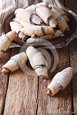 Freshly baked crescent with poppy stuffing close-up. vertical Stock Photo