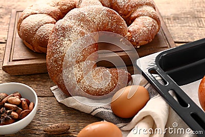 Freshly baked crescent rolls on wooden table Stock Photo