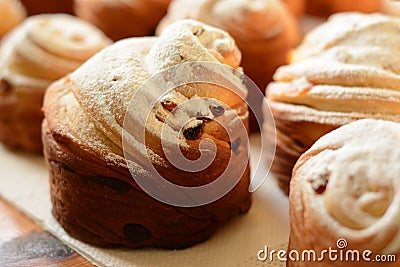Freshly baked fresh cruffins with raisins, dried apricots and powdered sugar. Stock Photo