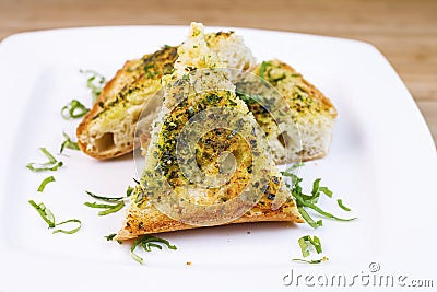 Freshly Baked Garlic Bread with herbs and butter Stock Photo