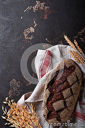 Freshly baked homemade bread on artisan sourdough rye on brawn stone or concrete background. Top view. Food cooking background. Co Stock Photo