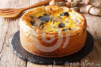 Freshly baked pie, quiche with boletus mushrooms, cheddar cheese Stock Photo