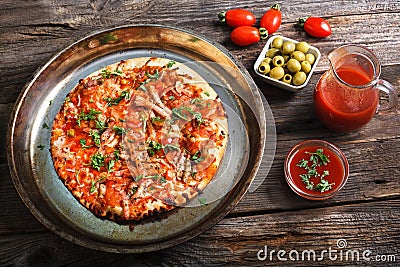 Freshly baked pizza on a wooden table Stock Photo
