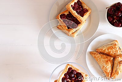Freshly baked puff pastry with cherries, flat lay Stock Photo