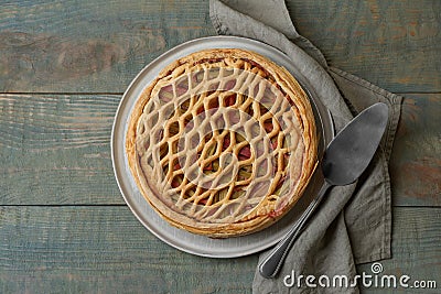 Freshly baked rhubarb pie and cake server on wooden table, flat lay Stock Photo