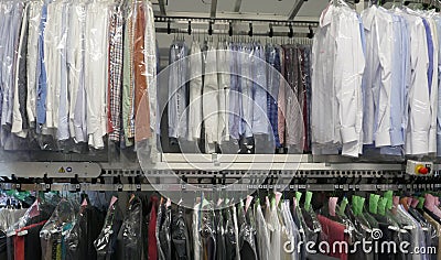 Freshly cleaned men`s shirts and ladies blouses in a textile cleaning Stock Photo