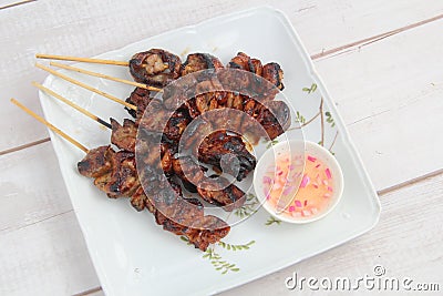 Freshly cooked Filipino food called Isaw baboy or grilled pork intestine Stock Photo