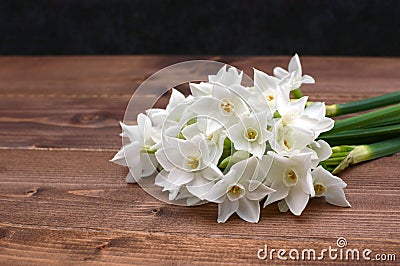 Freshly cut bunch of white narcissi on a wooden table Stock Photo