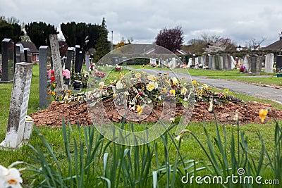 Freshly dug grave in cemetery Stock Photo