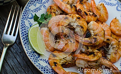 Freshly grilled shrimp on a plate with lime slice Stock Photo