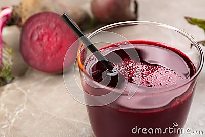 Freshly made beet juice in glass on grey table Stock Photo