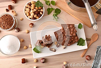 Freshly made chocolate with hazelnuts on white plate and tools Stock Photo
