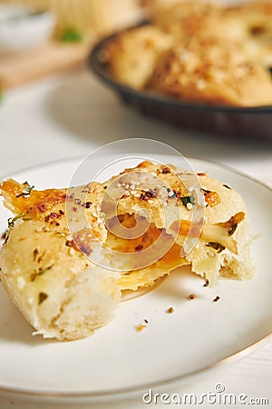 Freshly-made delicious cheese bubble pizza bread with ingredients and cheese on a white table Stock Photo