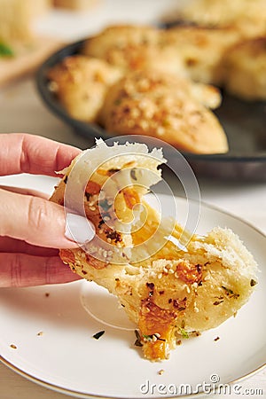 Freshly-made delicious cheese bubble pizza bread with ingredients and cheese on a white table Stock Photo