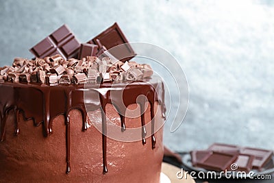 Freshly made delicious chocolate cake against background, closeup. Space for text Stock Photo