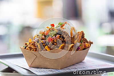 Freshly made nachos salsa on a tray in a paper plate at a street cafe Stock Photo