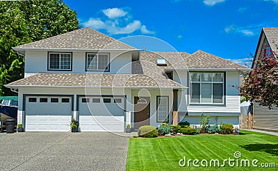 Nice lawn and entrance of beautiful residential house on sunny day Stock Photo