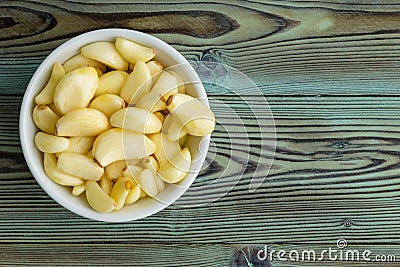 Freshly peeled aromatic garlic cloves in a ramekin Stock Photo