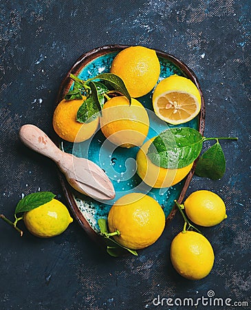Freshly picked lemons with leaves in blue ceramic plate Stock Photo
