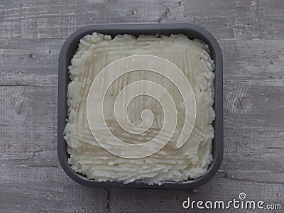 Freshly prepared cottage pie on a grey surface Stock Photo