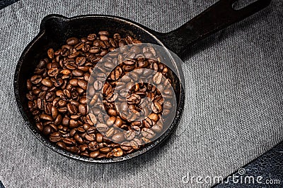 Freshly roasted coffee beans in a cast iron skillet Stock Photo