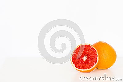 Freshly sliced grapefruit on white table/background Stock Photo